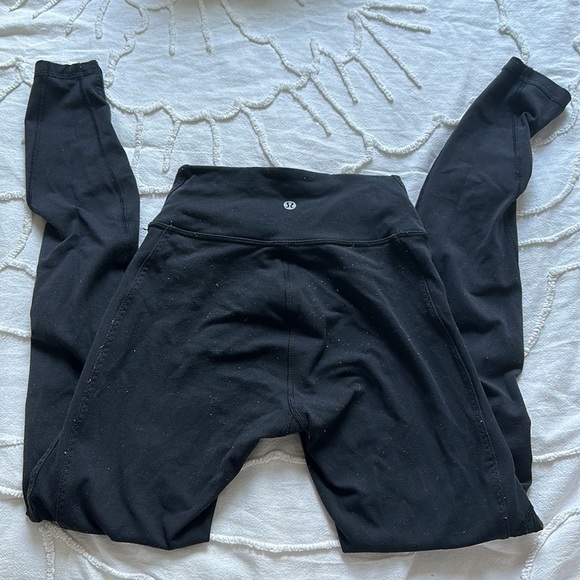 Black Lululemon leggings with criss cross on bottom of legs - Picture 2 of 4
